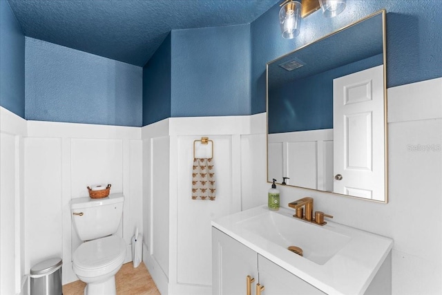 2753 Glenridge Cir, Merritt Island, FL 32953 - bathroom featuring toilet, vanity, tile patterned floors, and a textured wall