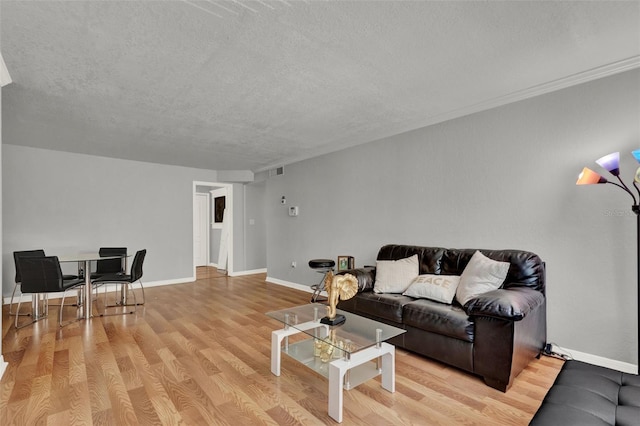 1940 S Conway Rd Unit 8, Orlando, FL 32812 - living area featuring a textured ceiling and light wood finished floors