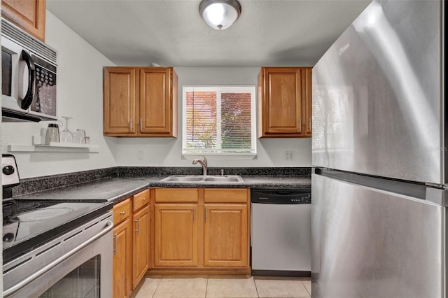1940 S Conway Rd Unit 8, Orlando, FL 32812 - kitchen with appliances with stainless steel finishes, dark countertops, light tile patterned flooring, and brown cabinets