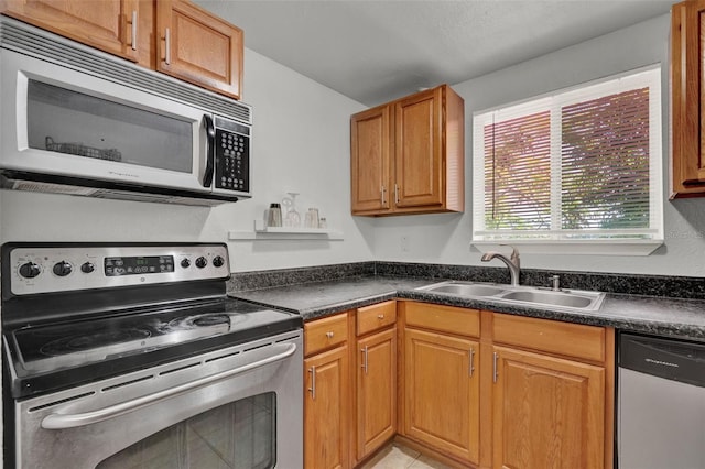 1940 S Conway Rd Unit 8, Orlando, FL 32812 - kitchen featuring stainless steel appliances, dark countertops, brown cabinetry, and lofted ceiling