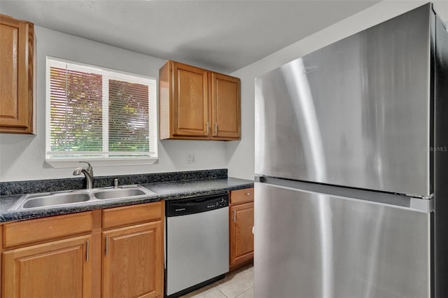 1940 S Conway Rd Unit 8, Orlando, FL 32812 - kitchen featuring appliances with stainless steel finishes, dark countertops, light tile patterned floors, and brown cabinets