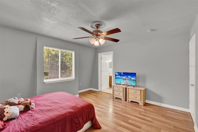 1940 S Conway Rd Unit 8, Orlando, FL 32812 - bedroom with light wood-type flooring, ceiling fan, a textured ceiling, and connected bathroom
