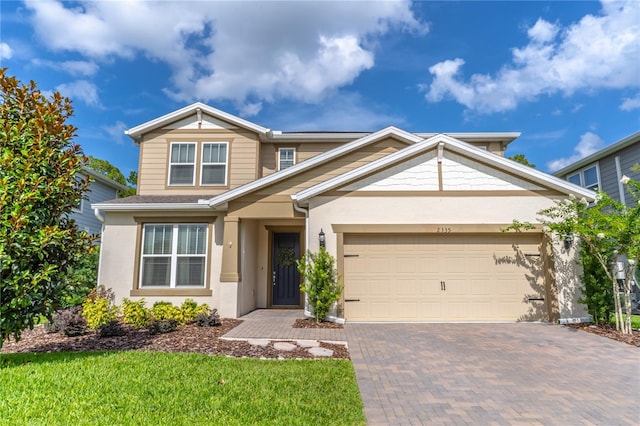 2335 Green Symphony Pl, Oviedo, FL 32765 - view of front of home featuring decorative driveway, a garage, and stucco siding