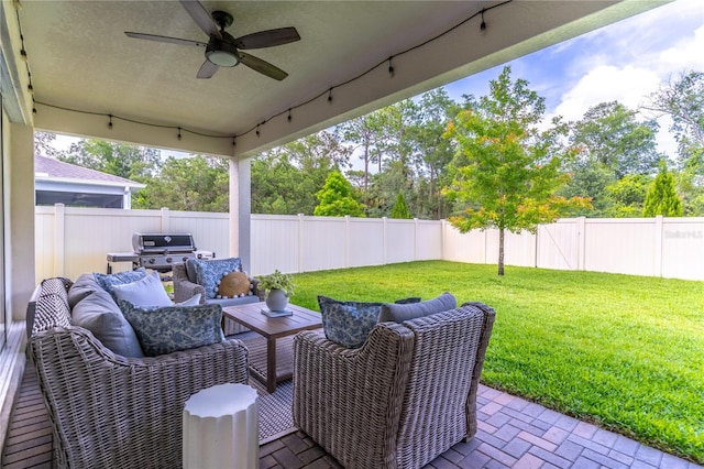 2335 Green Symphony Pl, Oviedo, FL 32765 - fenced backyard featuring outdoor lounge area, ceiling fan, a patio area, and a grill