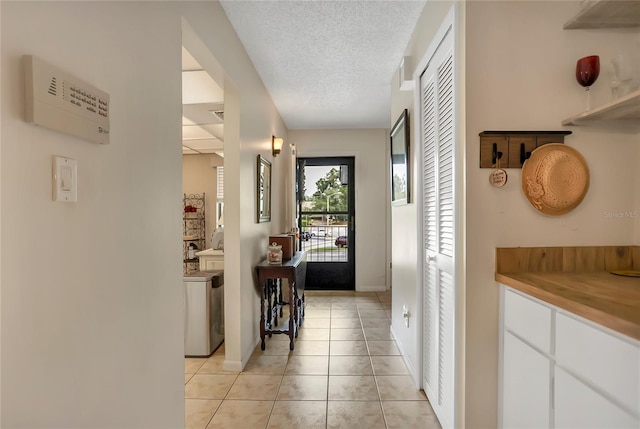 14 Escondido Ct Unit 134, Altamonte Springs, FL 32701 - corridor with light tile patterned floors, a textured ceiling, and baseboards