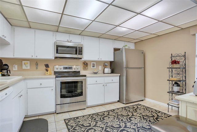 14 Escondido Ct Unit 134, Altamonte Springs, FL 32701 - kitchen featuring appliances with stainless steel finishes, light tile patterned floors, light countertops, white cabinets, and a paneled ceiling