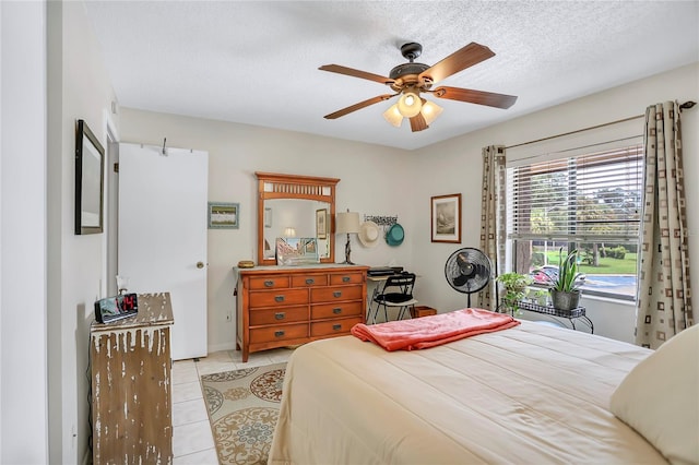 14 Escondido Ct Unit 134, Altamonte Springs, FL 32701 - bedroom featuring tile patterned flooring, a textured ceiling, and a ceiling fan