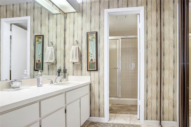 14 Escondido Ct Unit 134, Altamonte Springs, FL 32701 - full bathroom featuring a stall shower, vanity, tile patterned flooring, and wood walls