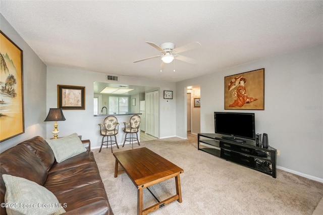 1515 Huntington Ln Unit 426, Rockledge, FL 32955 - carpeted living area featuring ceiling fan, baseboards, and a sink