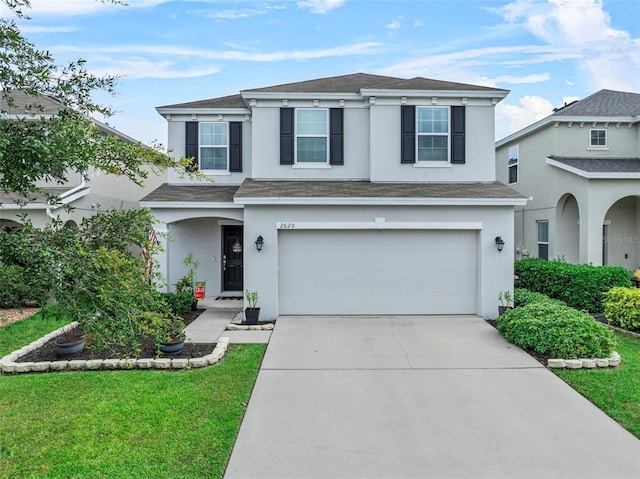 2620 Waterline St, Kissimmee, FL 34743 - traditional home featuring stucco siding, concrete driveway, an attached garage, roof with shingles, and a front lawn