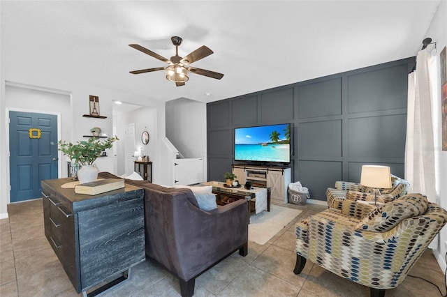 2620 Waterline St, Kissimmee, FL 34743 - living room with a decorative wall, a ceiling fan, light tile patterned floors, and stairs