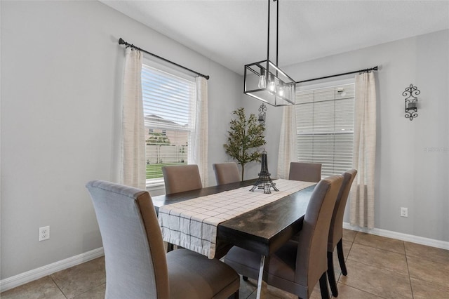 2620 Waterline St, Kissimmee, FL 34743 - dining area featuring a chandelier, baseboards, and light tile patterned flooring