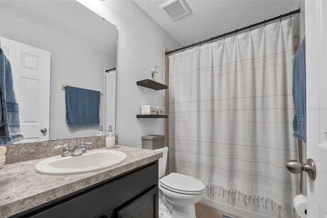 2620 Waterline St, Kissimmee, FL 34743 - full bath with toilet, vanity, a textured ceiling, shower / bath combo, and tile patterned flooring