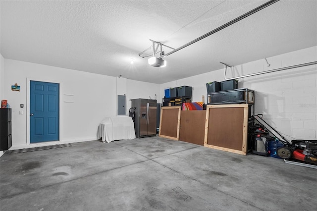 2620 Waterline St, Kissimmee, FL 34743 - garage with stainless steel fridge, electric panel, a garage door opener, and concrete block wall