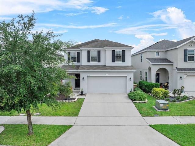 2620 Waterline St, Kissimmee, FL 34743 - traditional-style house featuring stucco siding, an attached garage, concrete driveway, a front yard, and roof with shingles