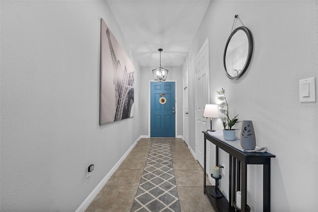 2620 Waterline St, Kissimmee, FL 34743 - tiled foyer entrance with a chandelier and baseboards