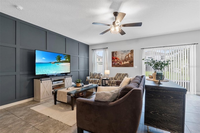 2620 Waterline St, Kissimmee, FL 34743 - living area with a decorative wall, ceiling fan, light tile patterned floors, and a textured ceiling