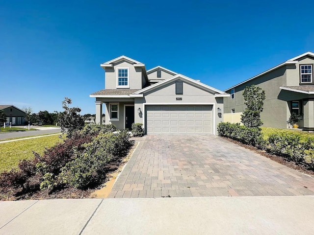 2807 Alder Berry Blvd, Ocoee, FL 34761 - view of front of house featuring stucco siding, decorative driveway, and a garage