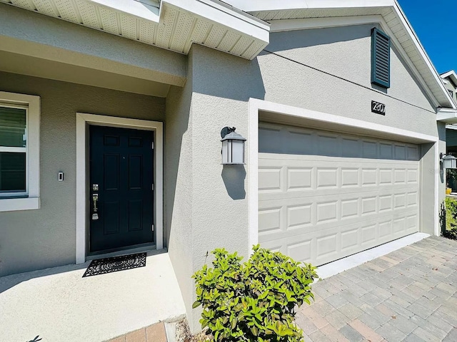 2807 Alder Berry Blvd, Ocoee, FL 34761 - doorway to property with stucco siding and a garage