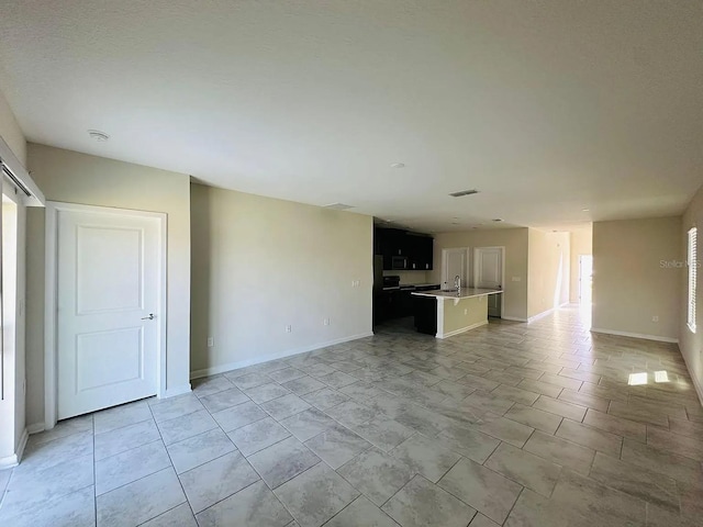 2807 Alder Berry Blvd, Ocoee, FL 34761 - unfurnished living room with a sink and baseboards