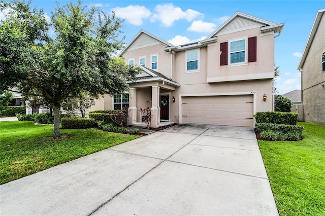 750 Maple Leaf Loop, Winter Springs, FL 32708 - view of front of home featuring stucco siding, a garage, concrete driveway, and a front yard