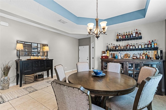 750 Maple Leaf Loop, Winter Springs, FL 32708 - tiled dining room with a dry bar, a chandelier, a raised ceiling, and baseboards