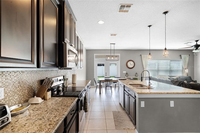 750 Maple Leaf Loop, Winter Springs, FL 32708 - kitchen featuring a sink, stainless steel appliances, open floor plan, ceiling fan, and light stone counters