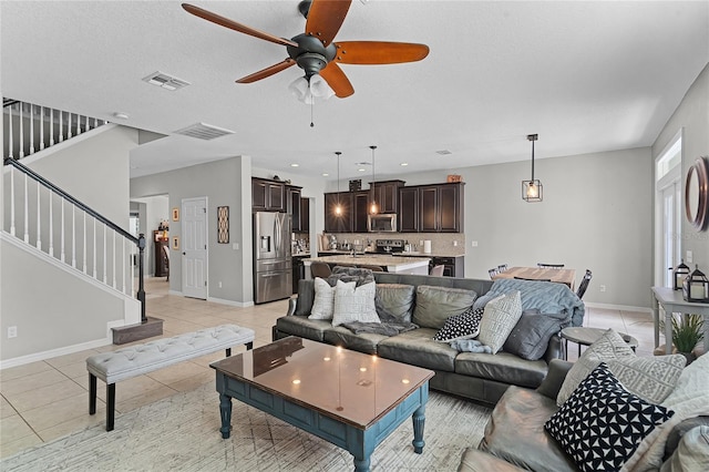 750 Maple Leaf Loop, Winter Springs, FL 32708 - living area featuring light tile patterned floors, stairway, a ceiling fan, and baseboards