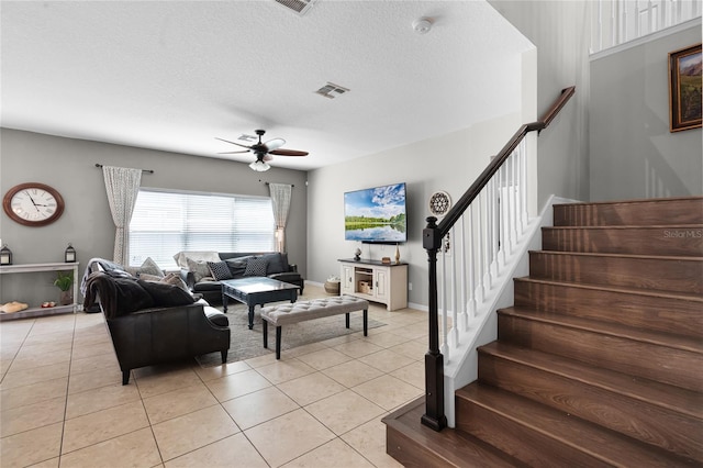 750 Maple Leaf Loop, Winter Springs, FL 32708 - living area with light tile patterned floors, a ceiling fan, stairs, a textured ceiling, and baseboards