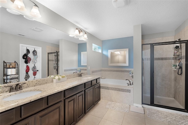 750 Maple Leaf Loop, Winter Springs, FL 32708 - bathroom with tile patterned floors, a stall shower, a bath, double vanity, and a textured ceiling