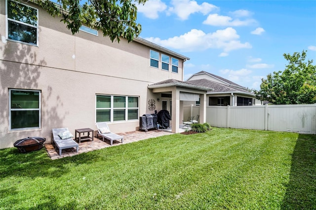 750 Maple Leaf Loop, Winter Springs, FL 32708 - rear view of property featuring a patio, a fire pit, and stucco siding