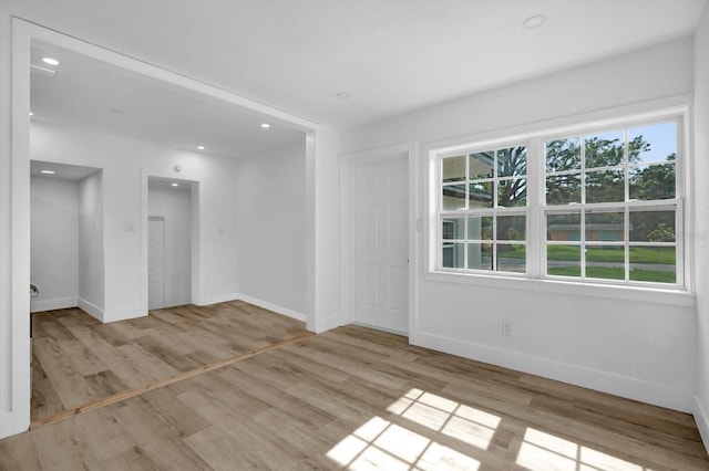 906 Kensington Dr, Orlando, FL 32808 - unfurnished room with baseboards, wood finished floors, and recessed lighting