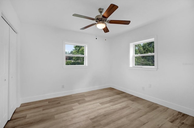 906 Kensington Dr, Orlando, FL 32808 - unfurnished bedroom with a closet, baseboards, light wood-type flooring, and ceiling fan