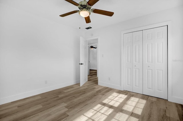906 Kensington Dr, Orlando, FL 32808 - unfurnished bedroom with light wood-style floors, baseboards, a closet, and ceiling fan