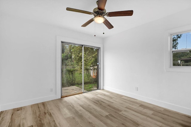906 Kensington Dr, Orlando, FL 32808 - empty room featuring wood finished floors, baseboards, and a ceiling fan