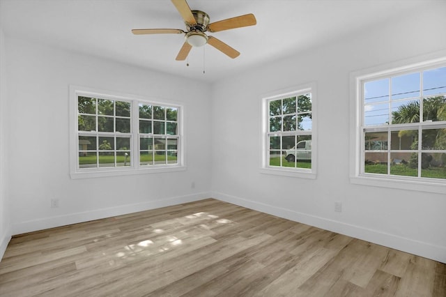 906 Kensington Dr, Orlando, FL 32808 - empty room with healthy amount of natural light, baseboards, and light wood finished floors