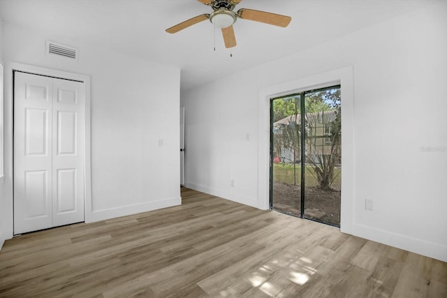 906 Kensington Dr, Orlando, FL 32808 - unfurnished bedroom featuring access to exterior, wood finished floors, baseboards, a ceiling fan, and a closet