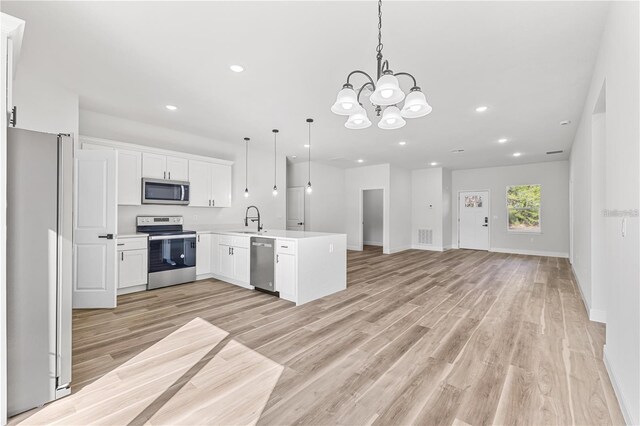 16730 SW 50th Cir, Ocala, FL 34473 - kitchen featuring stainless steel appliances, a sink, open floor plan, a peninsula, and light countertops