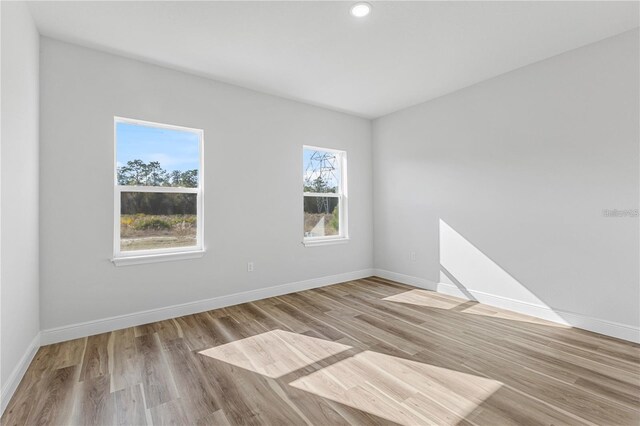 16730 SW 50th Cir, Ocala, FL 34473 - spare room featuring baseboards, wood finished floors, and recessed lighting
