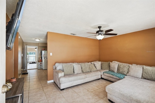 6663 NW 60th St, Ocala, FL 34482 - living room featuring a ceiling fan, light tile patterned flooring, and a textured ceiling