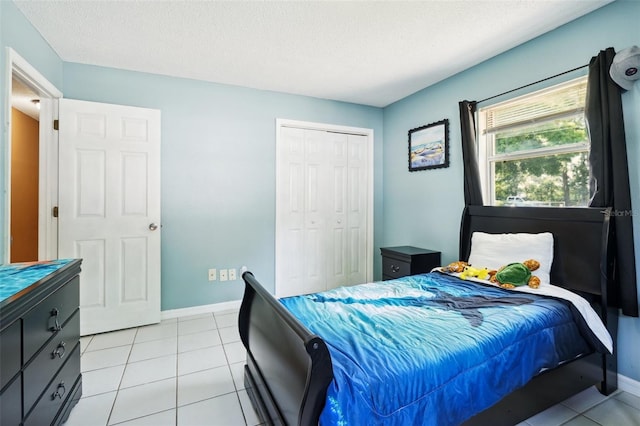 6663 NW 60th St, Ocala, FL 34482 - bedroom with a closet, light tile patterned floors, baseboards, and a textured ceiling