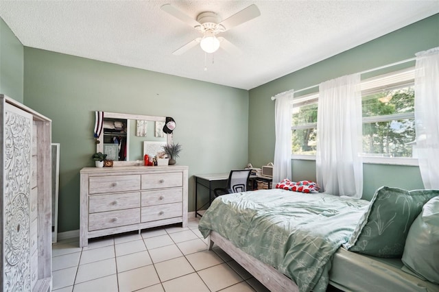 6663 NW 60th St, Ocala, FL 34482 - bedroom with a textured ceiling, light tile patterned flooring, a ceiling fan, and baseboards