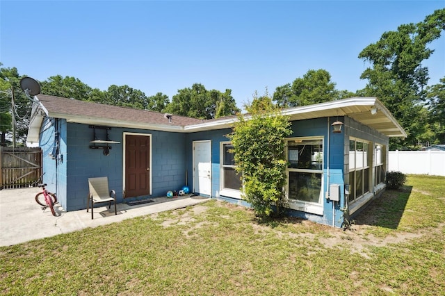6663 NW 60th St, Ocala, FL 34482 - back of property with concrete block siding, a patio area, and a shingled roof