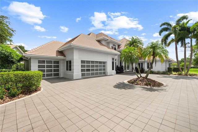 9138 Great Heron Cir, Orlando, FL 32836 - contemporary house with an attached garage, a tiled roof, driveway, and stucco siding