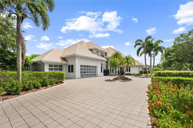 9138 Great Heron Cir, Orlando, FL 32836 - view of front of home featuring driveway, an attached garage, a tile roof, and stucco siding
