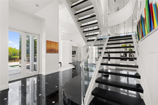 9138 Great Heron Cir, Orlando, FL 32836 - stairs with a towering ceiling and baseboards