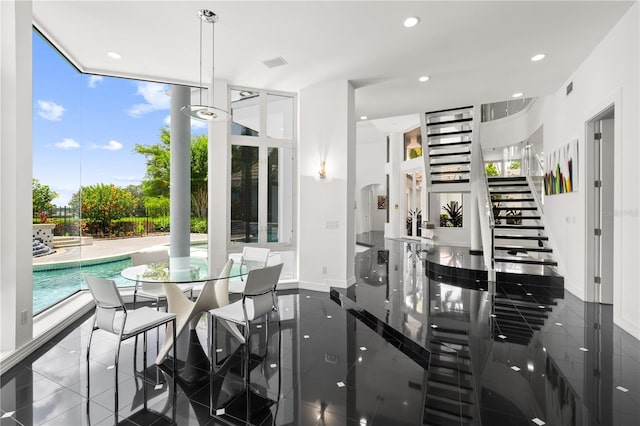 9138 Great Heron Cir, Orlando, FL 32836 - dining space with plenty of natural light, recessed lighting, stairway, and floor to ceiling windows