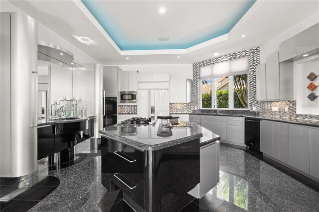 9138 Great Heron Cir, Orlando, FL 32836 - kitchen with built in appliances, granite tiled floors, modern cabinets, a kitchen island, and tasteful backsplash