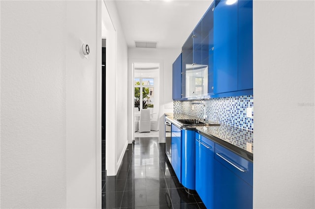 9138 Great Heron Cir, Orlando, FL 32836 - kitchen featuring blue cabinets, granite floors, decorative backsplash, dark countertops, and modern cabinets