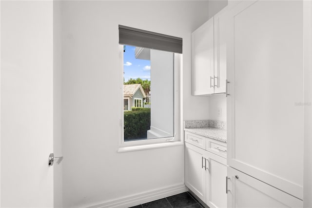 9138 Great Heron Cir, Orlando, FL 32836 - washroom with dark tile patterned flooring and baseboards